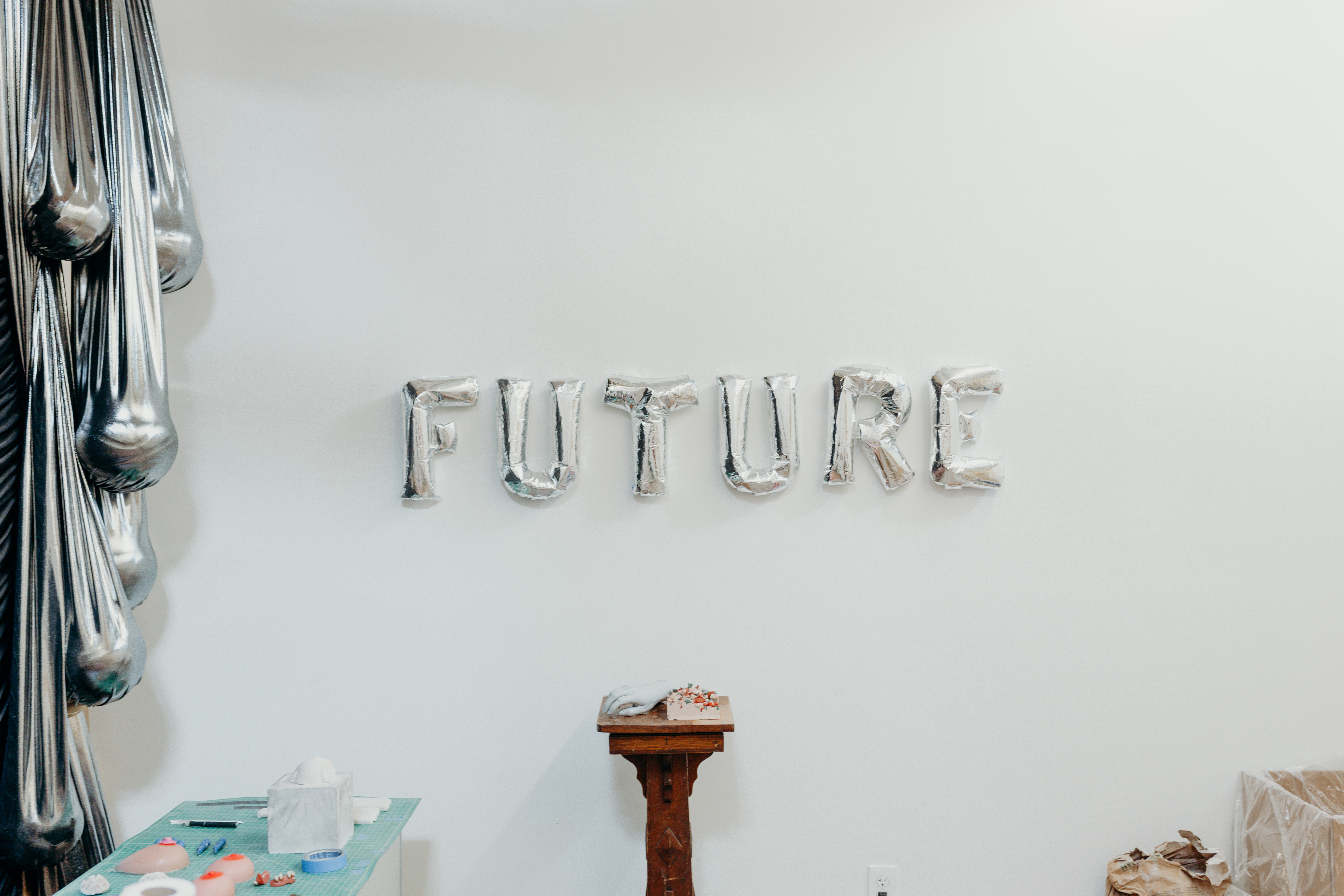 The word FUTURE is spelled out on the wall from balloons. 