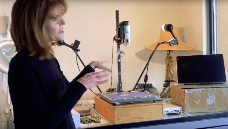 Screenshot of Stacey Steers in her studio space. It consists of a laptop and stop motion recording hardware. 